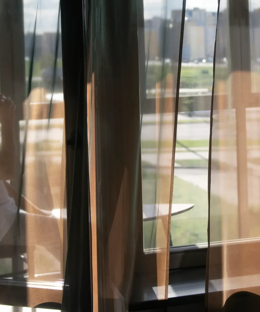 creative-portrait-man-with-curtains-shadows-from-window